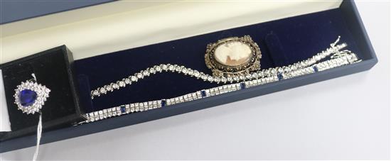 Four items of costume jewellery including a simulated diamond and sapphire bracelet and dress ring.